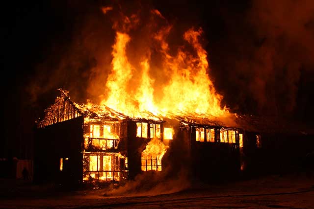 Home caught in flames at night